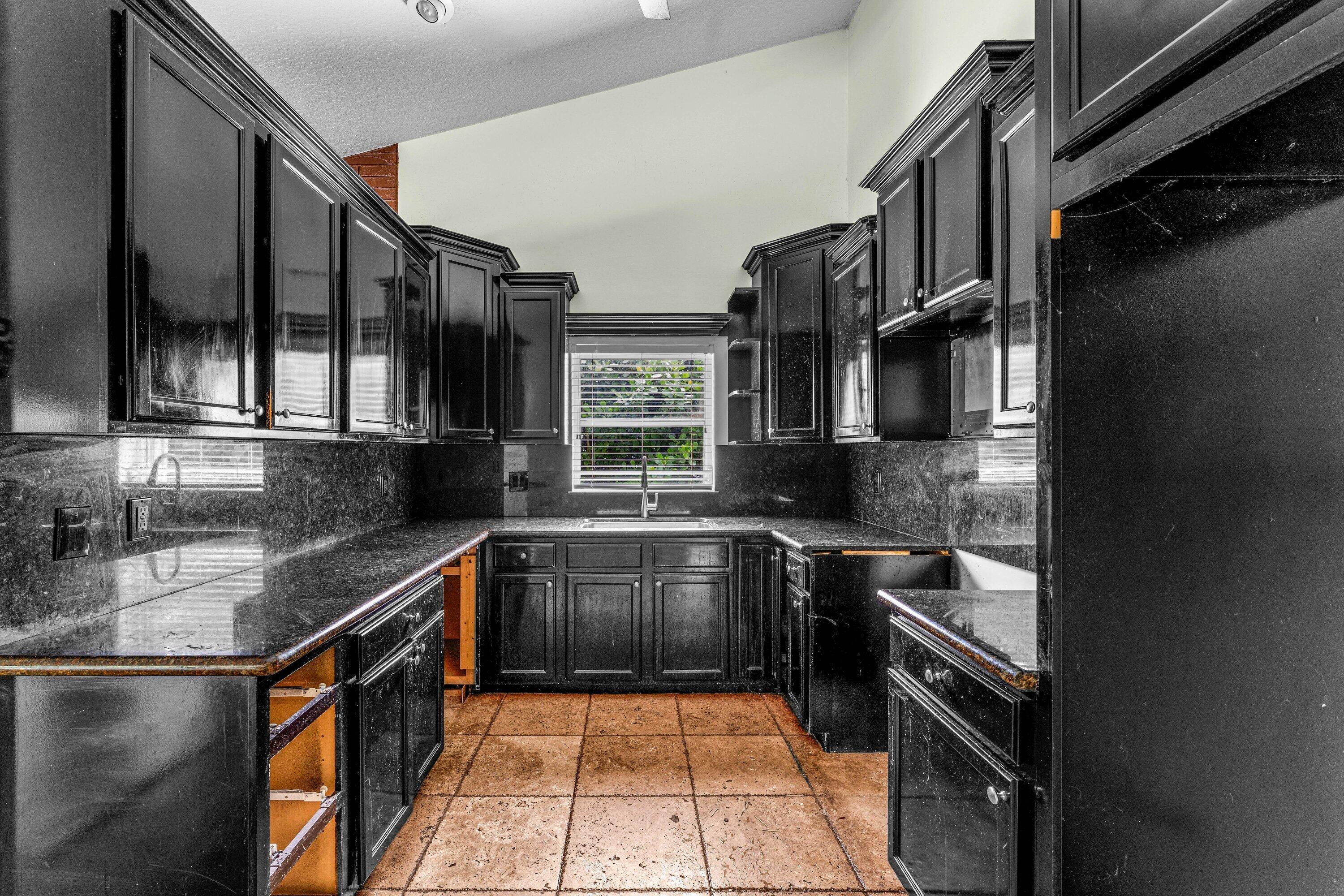2753 Northwest 34th Street Boca Raton, FL 33434 - Photo 8 of 41 a kitchen with stainless steel appliances granite countertop a sink stove and cabinets