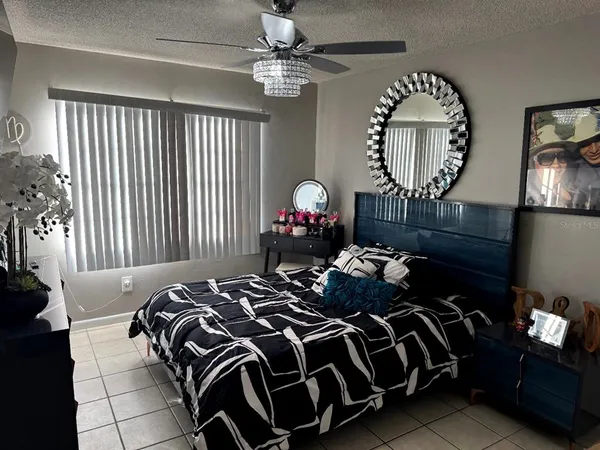 a bedroom with bed and a chandelier