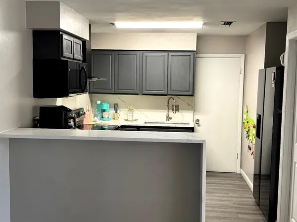 a kitchen with stainless steel appliances a sink and a refrigerator