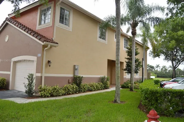 a front view of a house with a yard and outdoor seating