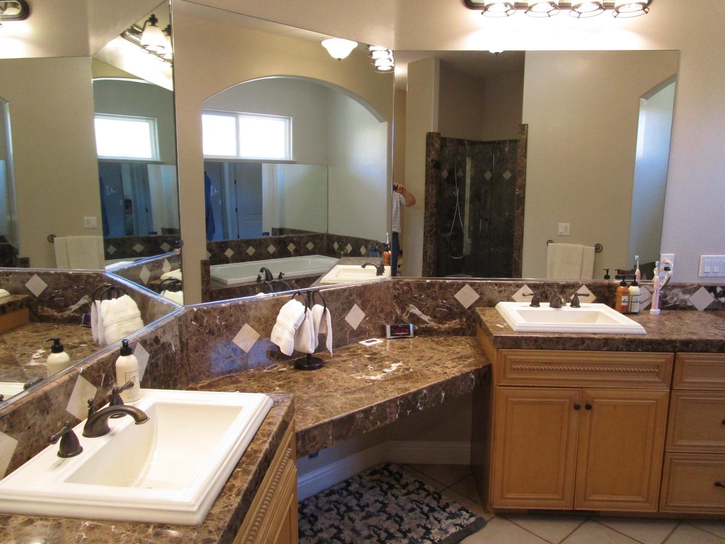 1320 Spring Grove Road Hollister, CA 95023 - Photo 12 of 51 a bathroom with a sink double vanity granite and a mirror