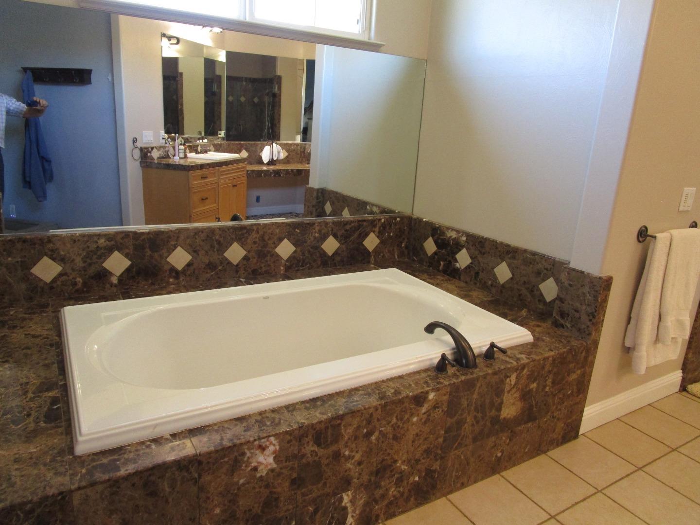 1320 Spring Grove Road Hollister, CA 95023 - Photo 14 of 51 a bathroom with a bathtub and a sink