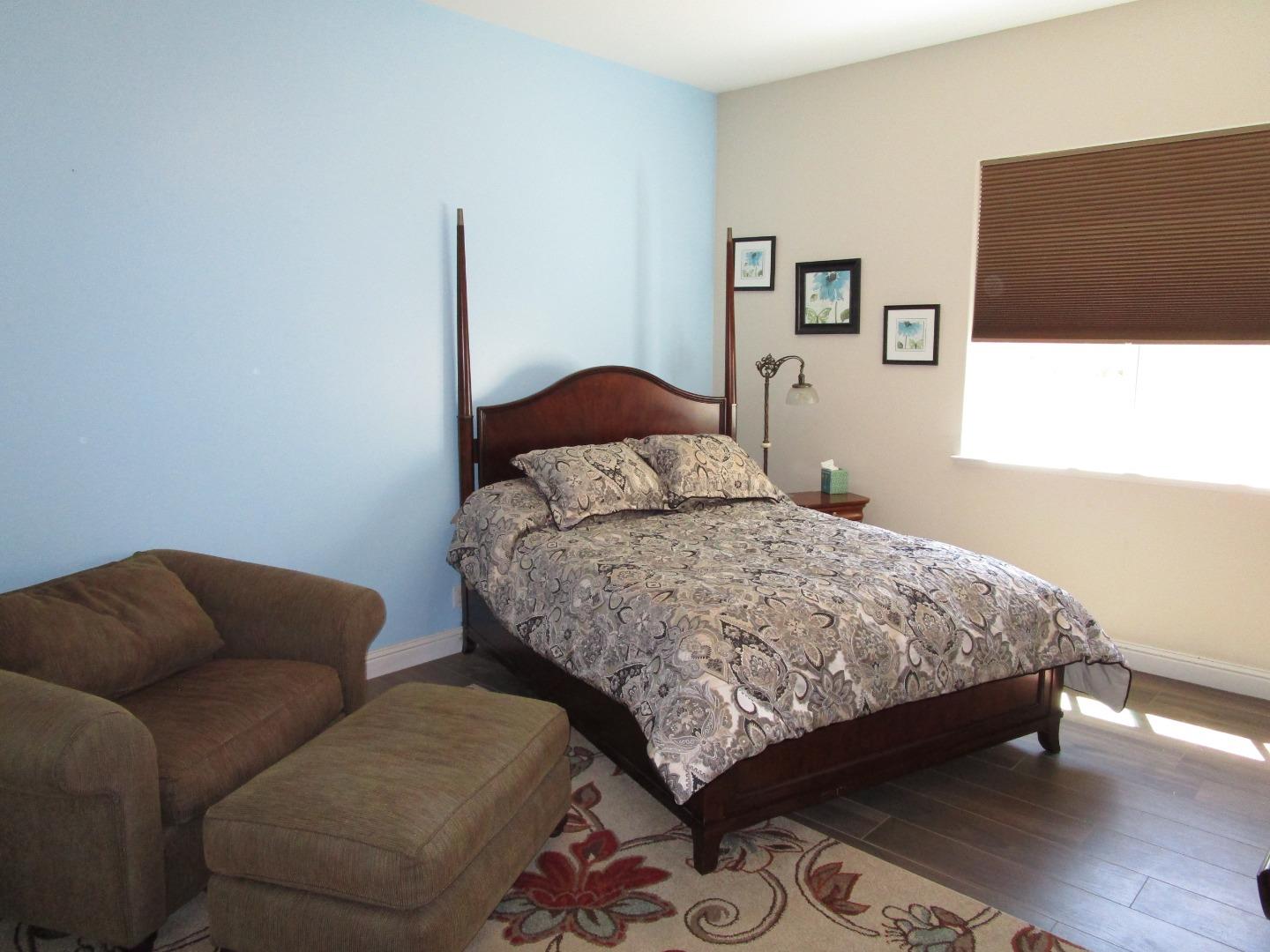 1320 Spring Grove Road Hollister, CA 95023 - Photo 15 of 51 a bedroom with bed and a couch