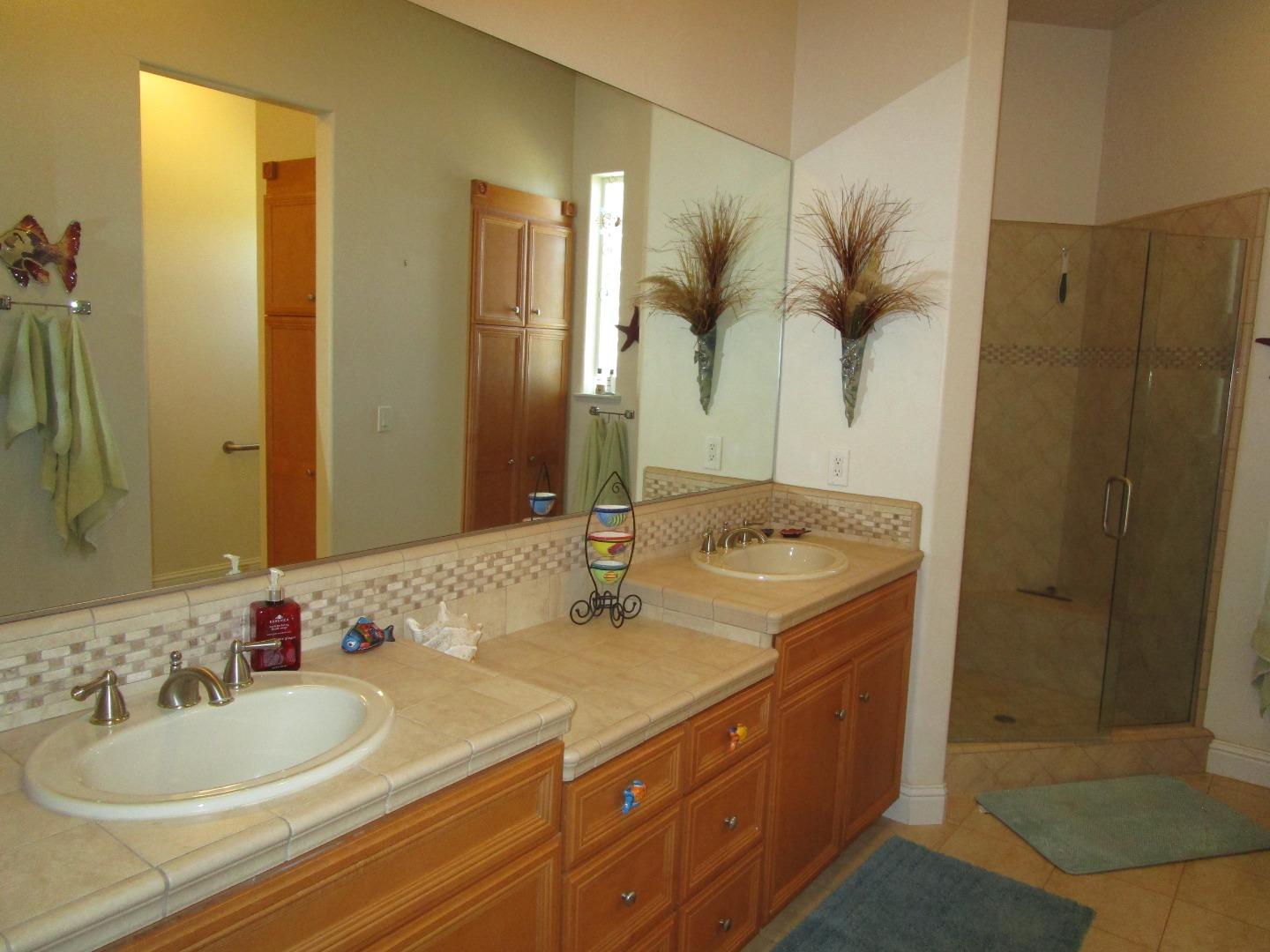 1320 Spring Grove Road Hollister, CA 95023 - Photo 16 of 51 a bathroom with a double vanity sink mirror and shower