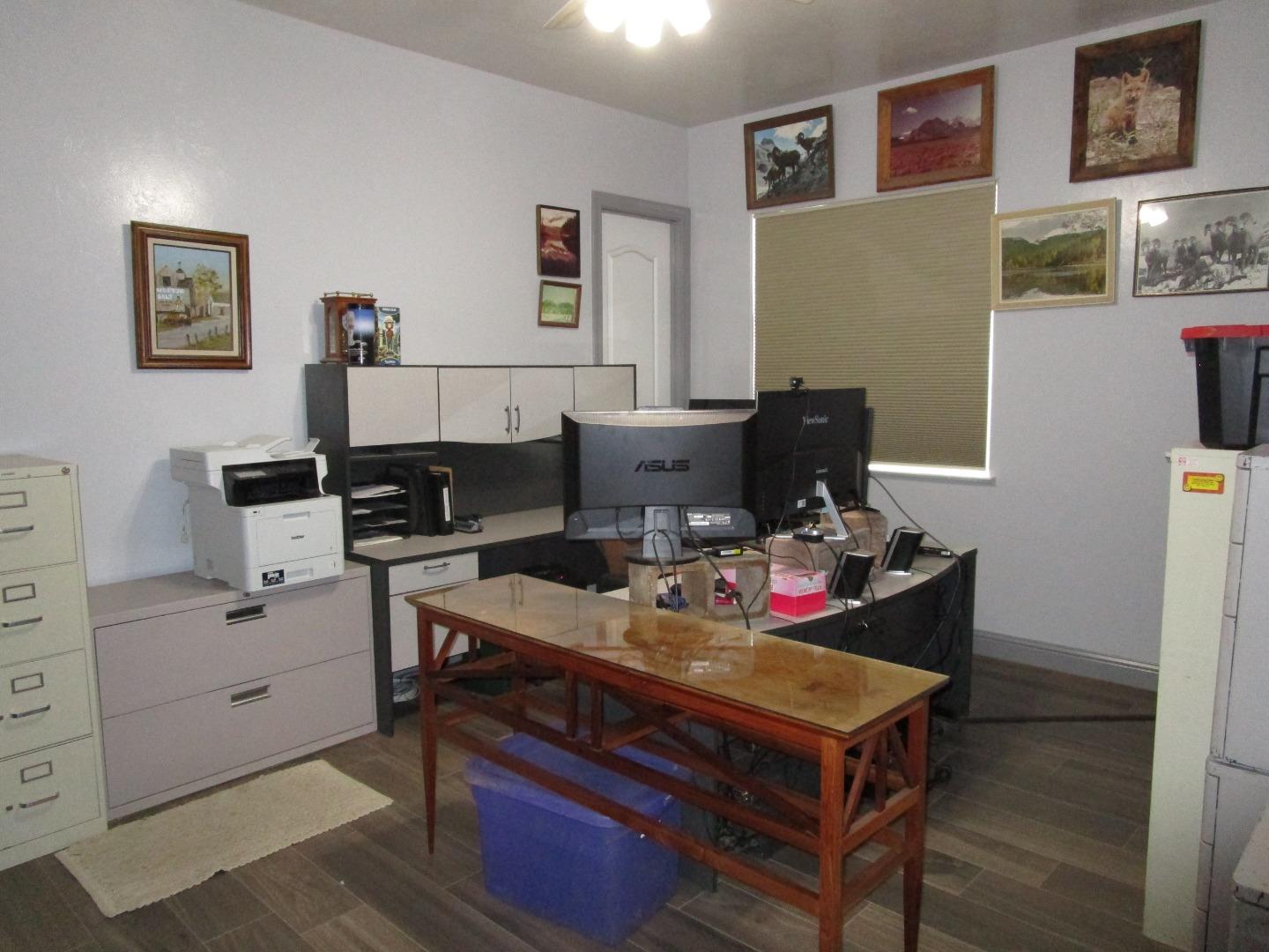 1320 Spring Grove Road Hollister, CA 95023 - Photo 18 of 51 a workspace with furniture and painting on the wall