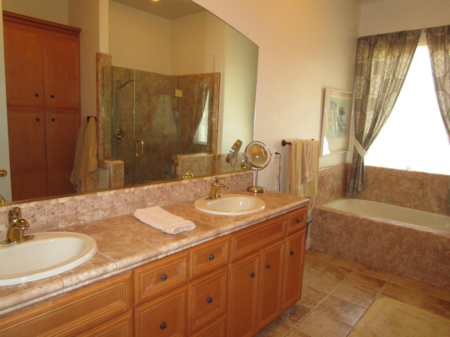 1320 Spring Grove Road Hollister, CA 95023 - Photo 19 of 51 a bathroom with a granite countertop sink and a mirror