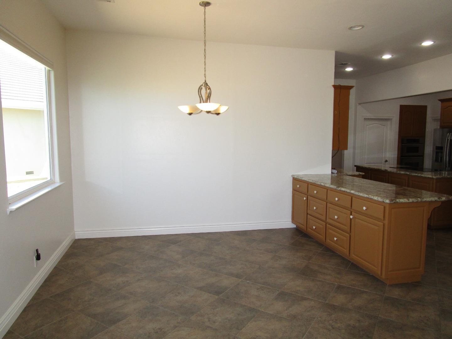 1320 Spring Grove Road Hollister, CA 95023 - Photo 27 of 51 a room with kitchen island stainless steel appliances a sink stove and cabinets