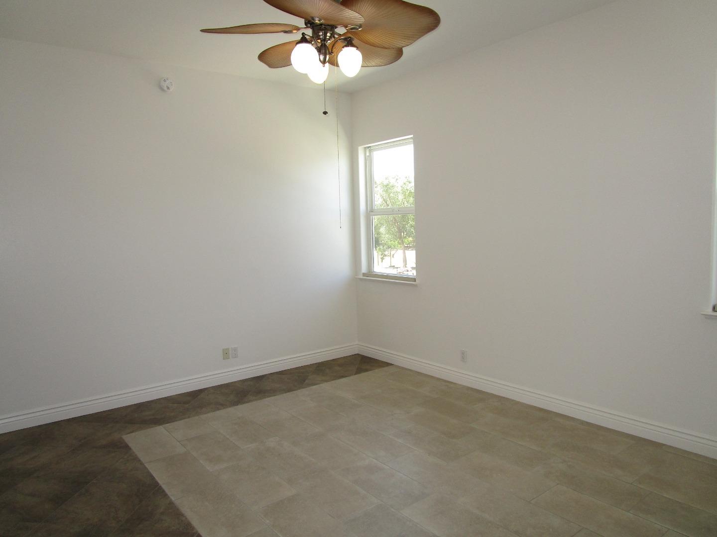 1320 Spring Grove Road Hollister, CA 95023 - Photo 30 of 51 an empty room with windows and fan