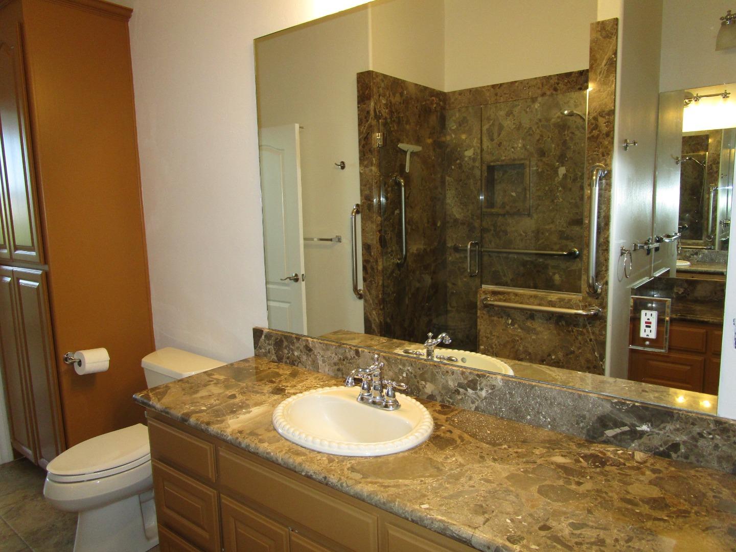 1320 Spring Grove Road Hollister, CA 95023 - Photo 32 of 51 a bathroom with a granite countertop sink toilet and shower