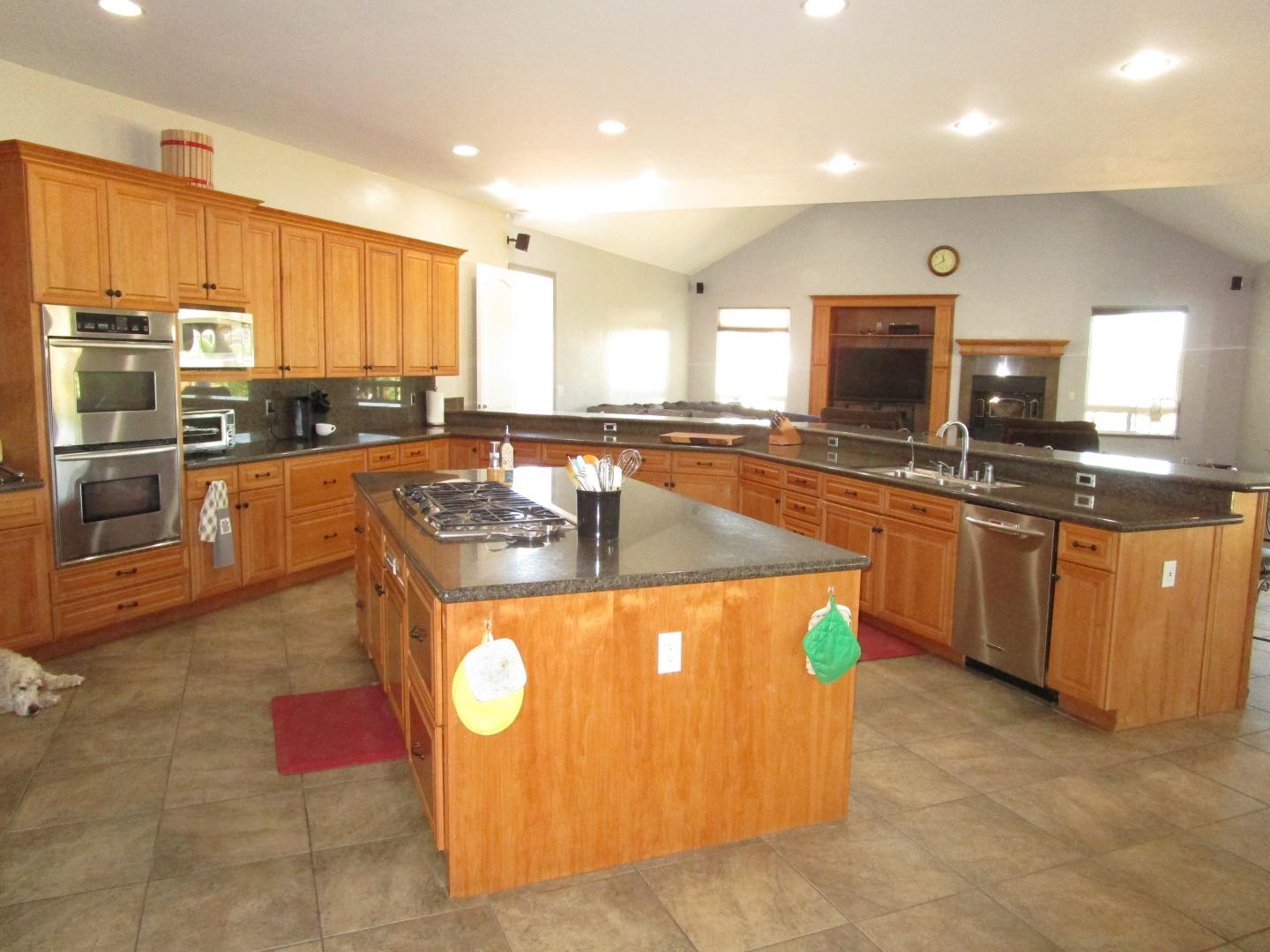 1320 Spring Grove Road Hollister, CA 95023 - Photo 5 of 51 a kitchen with stainless steel appliances granite countertop a sink a stove and a refrigerator