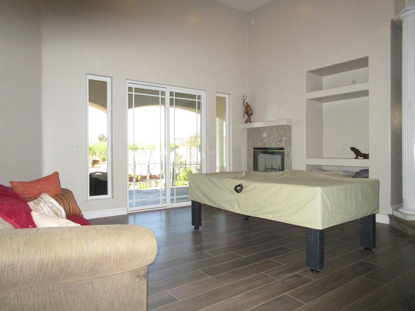 1320 Spring Grove Road Hollister, CA 95023 - Photo 8 of 51 a spacious bedroom with a bed and wooden floor