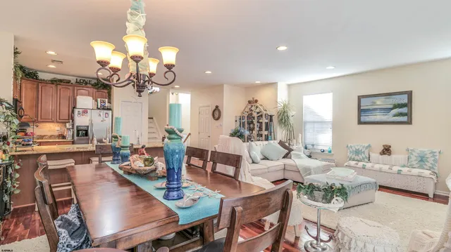 a living room with kitchen island furniture and a chandelier