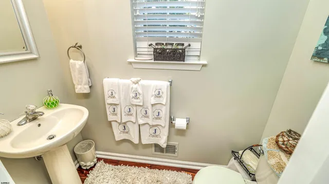 a bathroom with a sink mirror and toilet