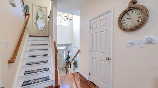 a view of a hallway with wooden floor and entryway