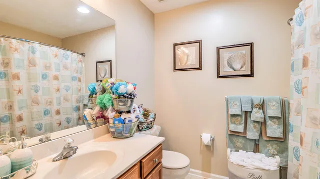 a bathroom with a sink mirror vanity and toilet