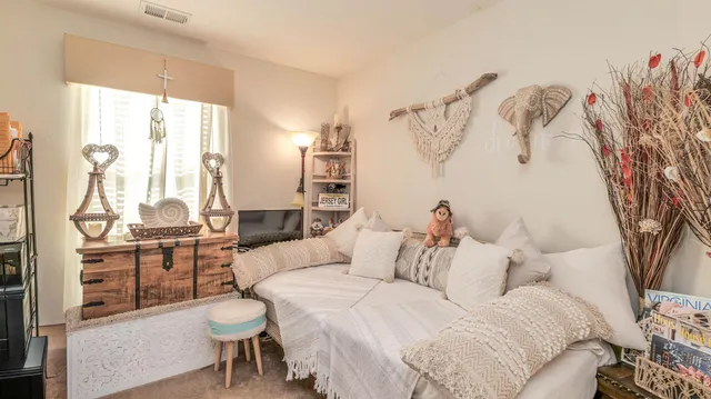 a spacious bedroom with a bed and a chandelier