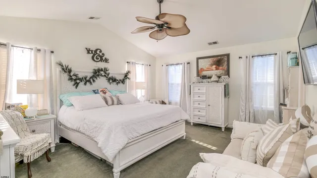 a bedroom with a large bed couch and a window