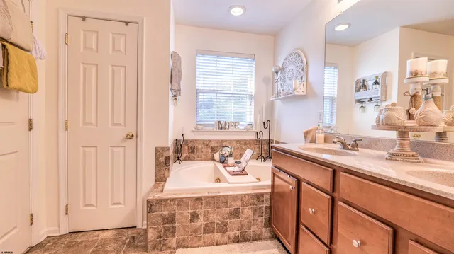 a bathroom with double vanity sinks a mirror and a shower