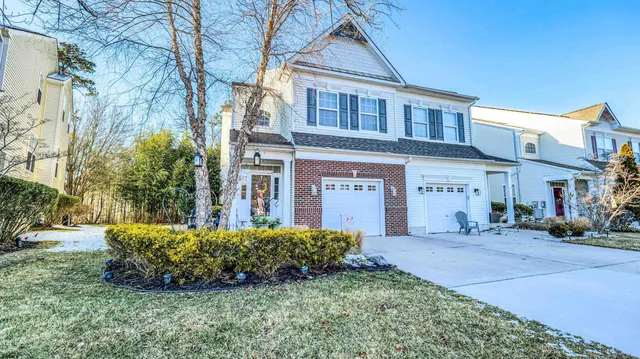 a view of a house with a yard and pathway