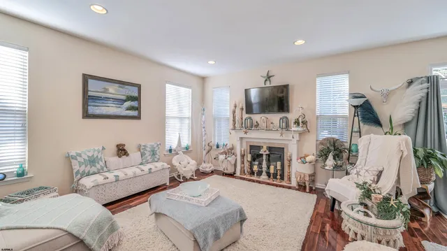 a living room with furniture a fireplace and a flat screen tv