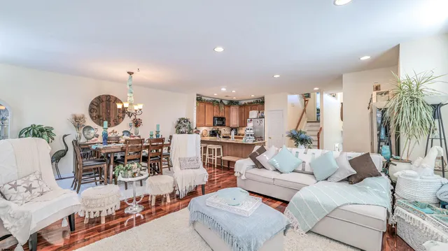 a living room with furniture and a large mirror