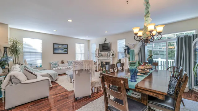 a view of a dining room with furniture wooden floor and chandelier