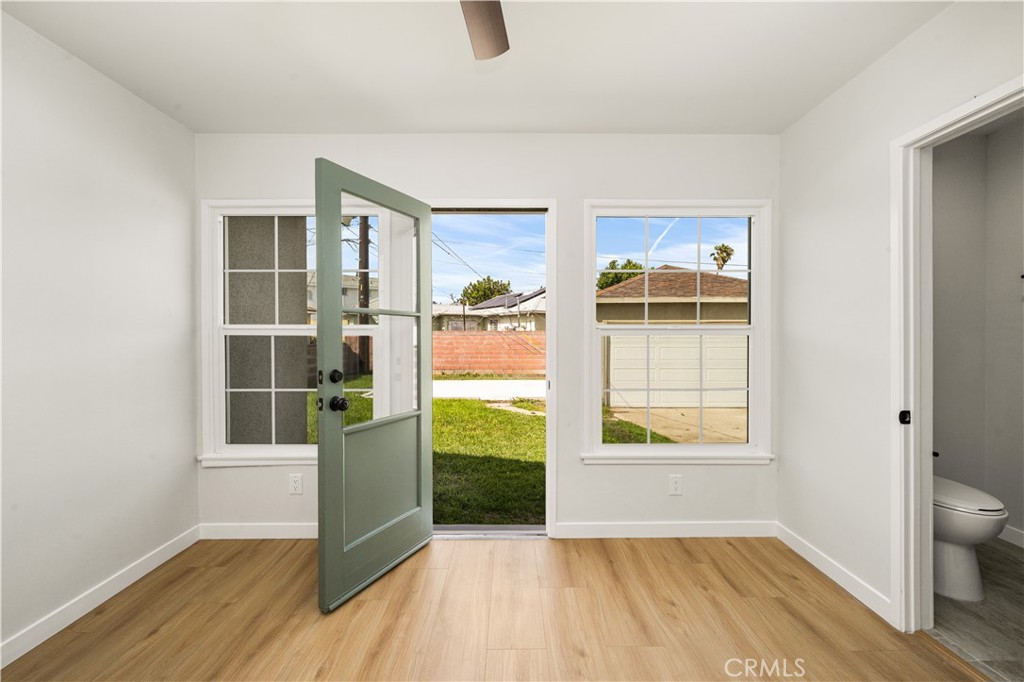 1013 West 138th Street Compton, CA 90222 - Photo 25 of 30 an empty room with wooden floor and a window