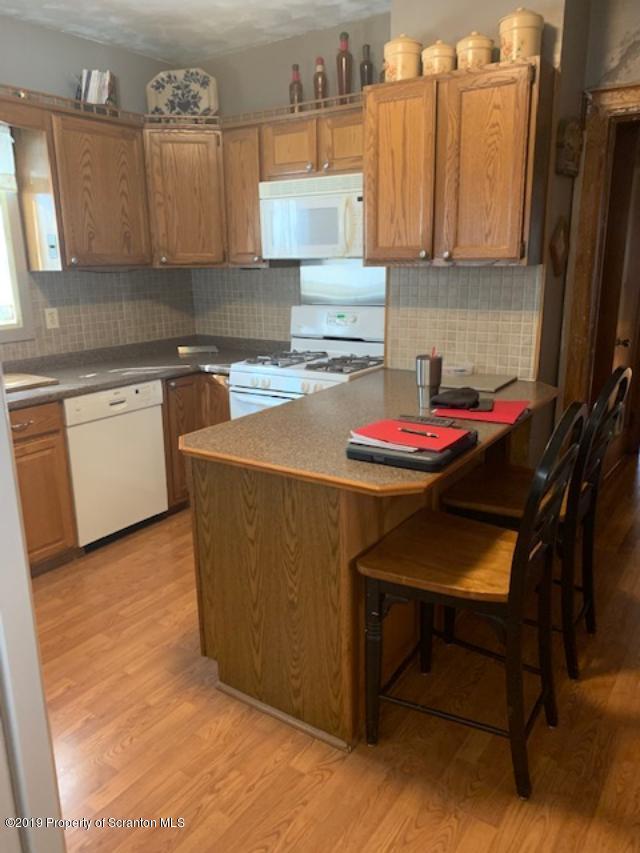 850 Main Street Duryea, PA 18642 - Photo 11 of 24 a kitchen with a sink cabinets and wooden floor