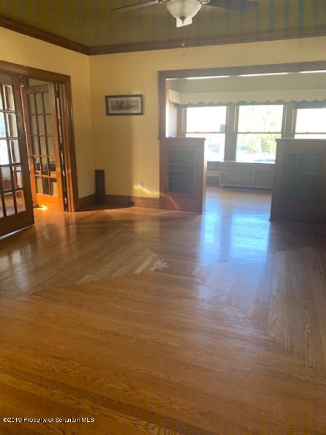 850 Main Street Duryea, PA 18642 - Photo 6 of 24 a view of empty room with wooden floor and fan