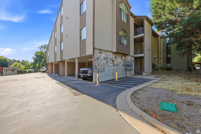 1175 Canyon Road, Unit 86 Ogden, UT 84404 - Photo 23 of 29 Multi-story building exterior featuring a stone facade base, vertical siding, and multiple balconies