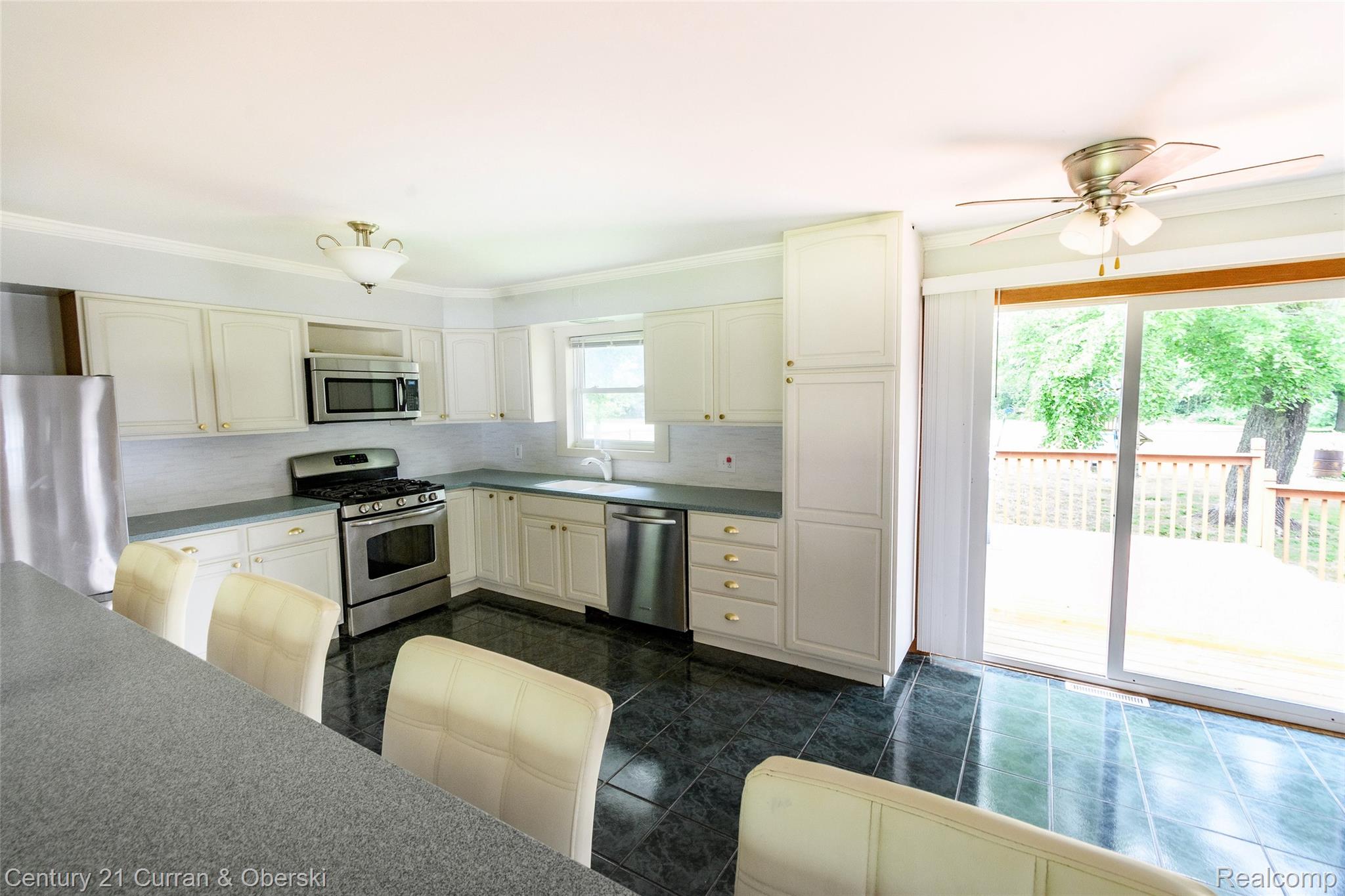 5260 Rives Junction Road Jackson, MI 49201 - Photo 12 of 44 Kitchen featuring white cabinetry, dark countertop surfaces, a full suite of stainless steel appliances, and dark tile flooring