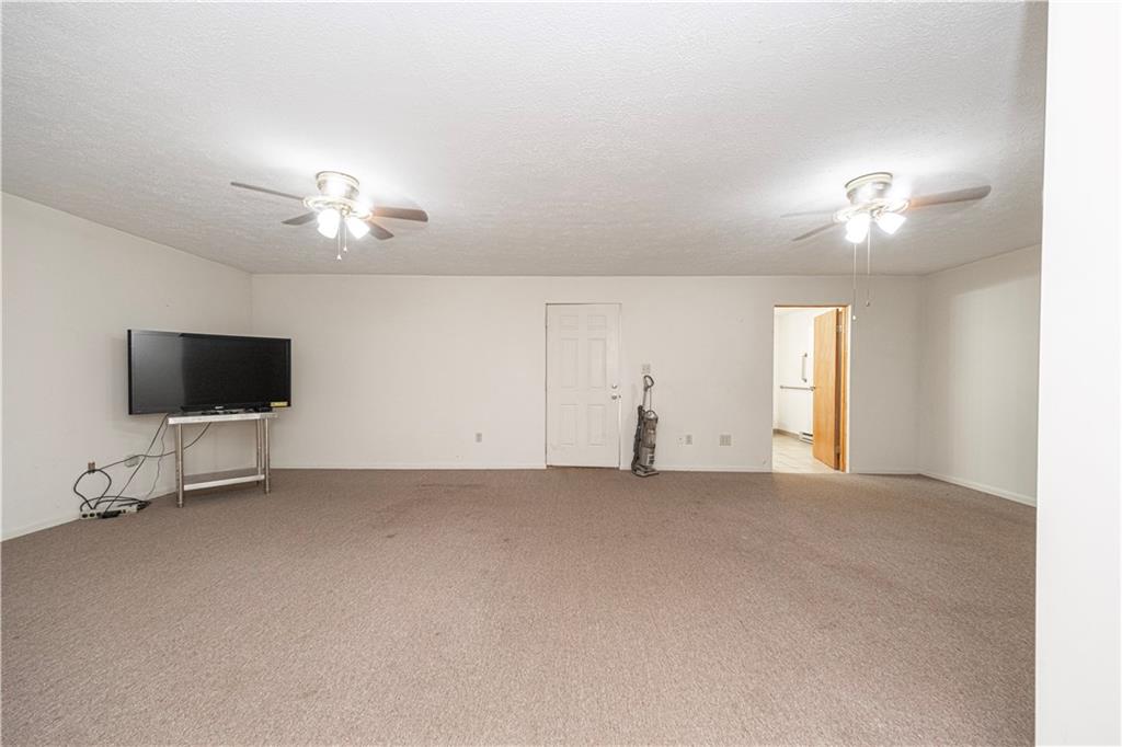 7300 Hutchinson Road Elizabeth, PA 15037 - Photo 20 of 42 There is a large multi-purpose room adjacent to the porch that was used as living space for a disabled family member. It is big enough to contain a bed, sofa, and dining table. The TV will be removed.
