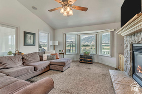 19 East Southfield Road Spanish Fork, UT 84660 - Photo 65 of 74 Living room with carpet floors, a fireplace, lofted ceiling, and a ceiling fan