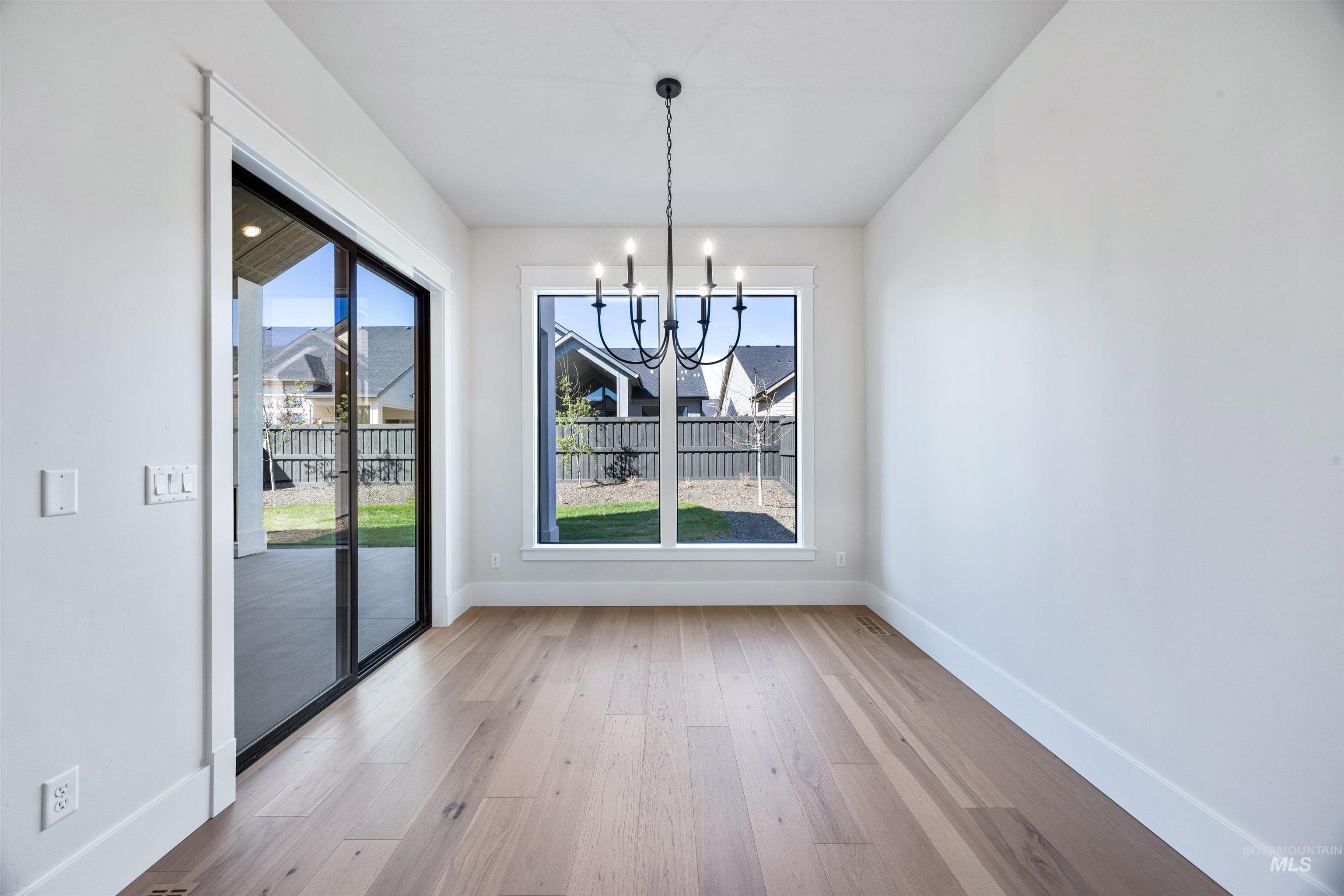 904 East Escalation Street Meridian, ID 83642 - Photo 13 of 36 Bright interior space with wide plank wood-finish flooring