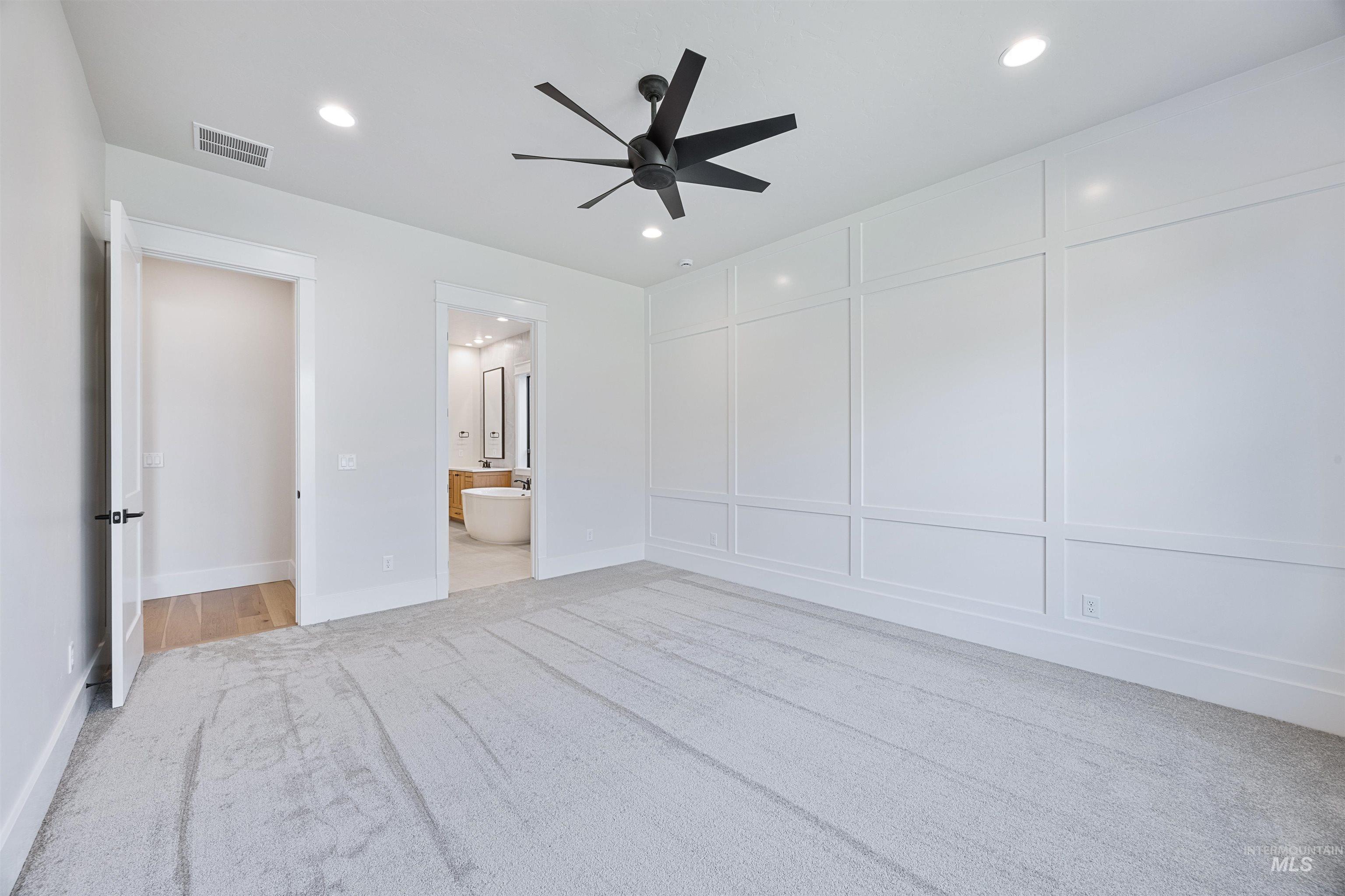 904 East Escalation Street Meridian, ID 83642 - Photo 28 of 36 Expansive room featuring light-toned carpeting and a decorative paneled accent wall