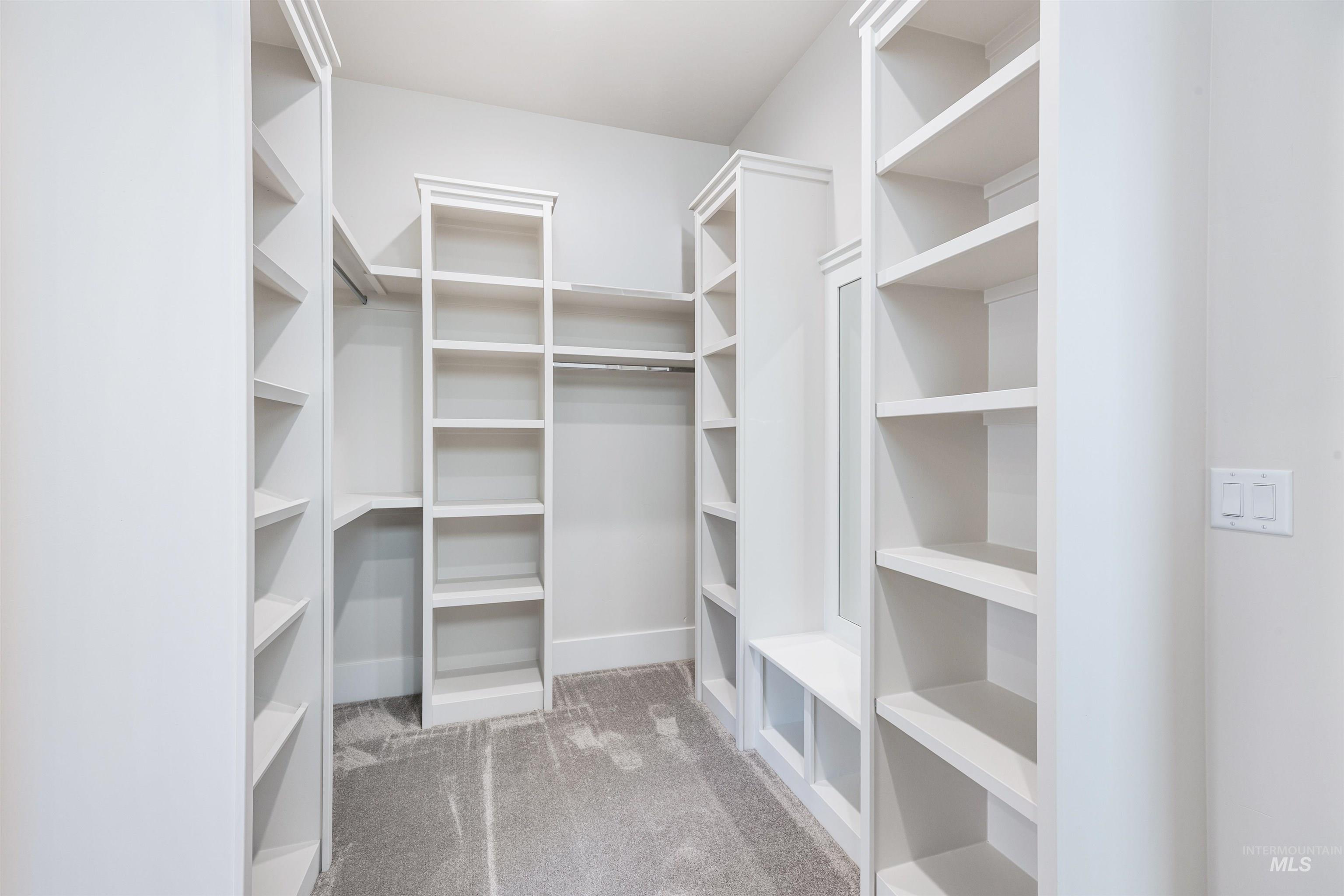 904 East Escalation Street Meridian, ID 83642 - Photo 33 of 36 Built-in closet system featuring multiple shelving units, hanging rods, and a seating bench