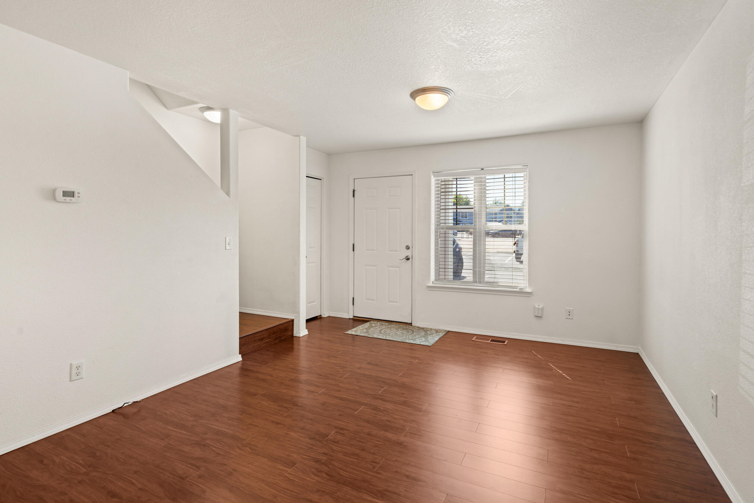 450 Midway Road, Unit 33 Medford, OR 97501 - Photo 5 of 21 an empty room with wooden floor and windows