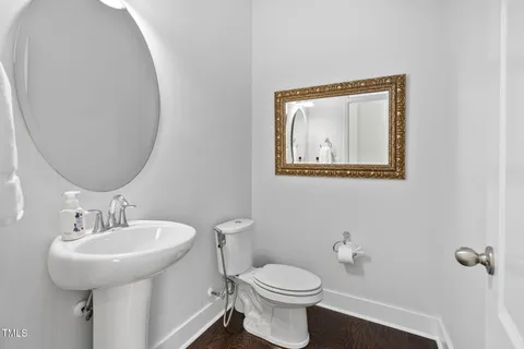a bathroom with a shower sink mirror and toilet