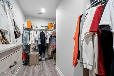 a view of a room with wooden floor and furniture