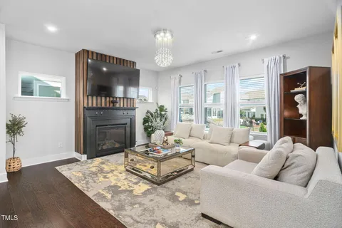 a living room with fireplace furniture and a flat screen tv