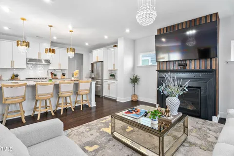 a kitchen with stainless steel appliances granite countertop a sink and a large window