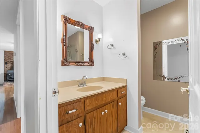 a bathroom with a sink vanity and mirror