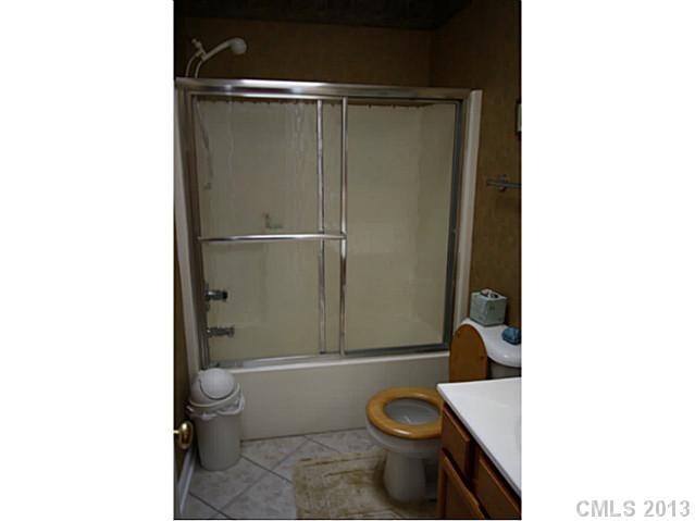 6526 Nevin Road Charlotte, NC 28262 - Photo 11 of 16 a bathroom with a toilet and a shower