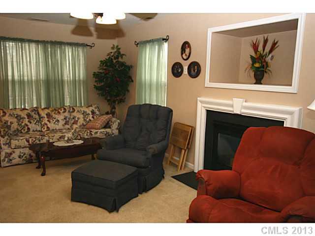6526 Nevin Road Charlotte, NC 28262 - Photo 3 of 16 a living room with furniture and a fireplace