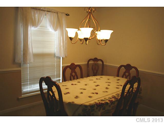 6526 Nevin Road Charlotte, NC 28262 - Photo 6 of 16 a view of a dining room with furniture and wooden floor