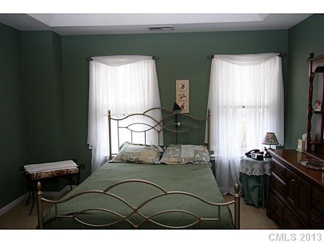 6526 Nevin Road Charlotte, NC 28262 - Photo 7 of 16 a bedroom with a bed and a television