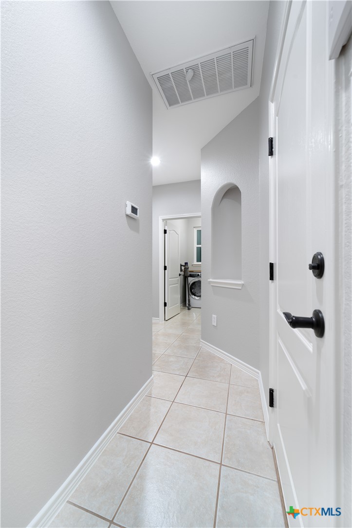 103 Sierra Ridge Drive San Marcos, TX 78666 - Photo 18 of 43 hallway going to laundry room and 2nd bedroom and bathroom downstairs