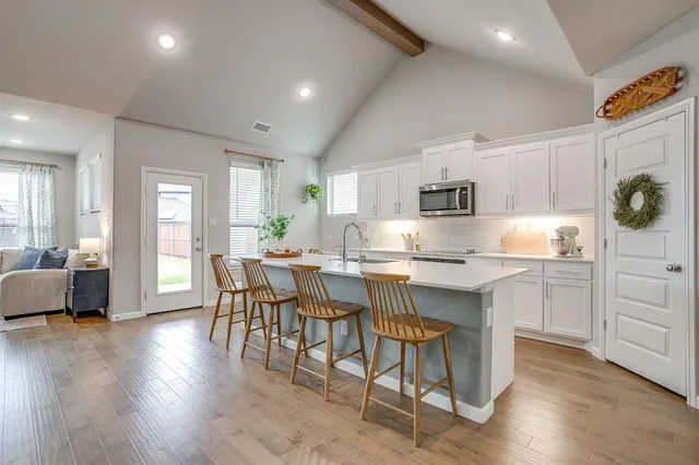 a kitchen with sink cabinets and wooden floor