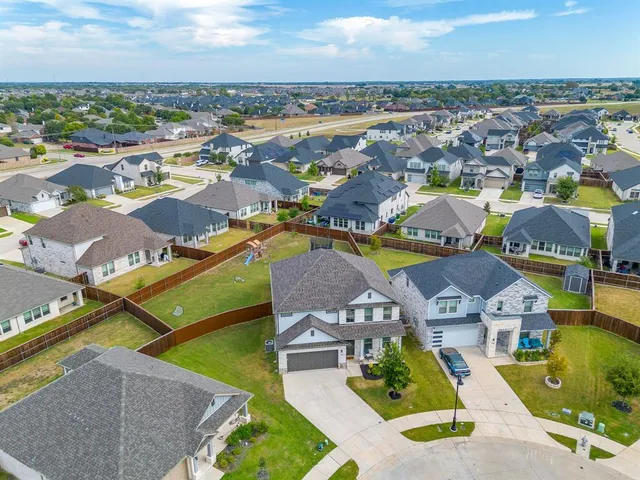 an aerial view of a house with a swimming pool