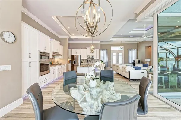 a view of a dining room with furniture wooden floor and a chandelier